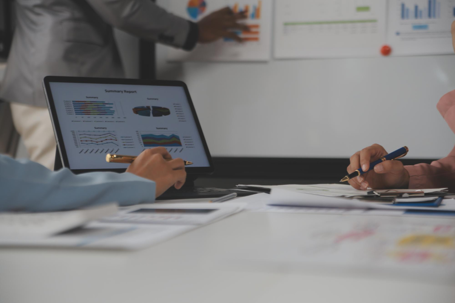 Close up of business team analyzing income charts and graphs